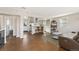 Open-concept living space featuring hardwood floors, a modern kitchen with stainless steel appliances, and natural light at 8074 Grove St, Westminster, CO 80031