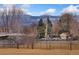 Scenic neighborhood view with mature trees and mountain backdrop at 8074 Grove St, Westminster, CO 80031