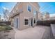 Charming back exterior with stucco, blue doors, private patio, and gravel landscaping at 4225 W 30Th Ave, Denver, CO 80212