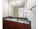 Bathroom vanity featuring granite countertop, cherry cabinets and large mirror at 4225 W 30Th Ave, Denver, CO 80212
