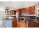 Spacious kitchen with granite countertops, modern appliances, and cherry cabinets at 4225 W 30Th Ave, Denver, CO 80212