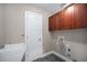Well-lit laundry room features a utility sink, ample cabinet space, and convenient washer/dryer hookups at 4225 W 30Th Ave, Denver, CO 80212