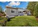 Backyard with a lush green lawn, a pair of chairs for relaxing, and an open air deck with shade at 4193 W 99Th Ct, Westminster, CO 80031