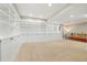 Expansive basement with built-in shelving, neutral carpet, and a comfortable living area at 4193 W 99Th Ct, Westminster, CO 80031