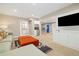 Large finished basement featuring a cozy seating area and built-in shelving and cabinets at 4193 W 99Th Ct, Westminster, CO 80031