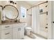 Well-lit bathroom with white cabinetry, granite countertop, and shower-tub combination at 4193 W 99Th Ct, Westminster, CO 80031