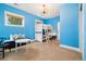 Bright bedroom with blue walls, a bunk bed, white trim and a window with a view to the outdoors at 4193 W 99Th Ct, Westminster, CO 80031