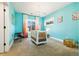Charming bedroom featuring bright walls, a modern crib, and ample natural light at 4193 W 99Th Ct, Westminster, CO 80031