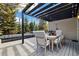Inviting deck with a wooden table, ample seating, shade, and a view of the surrounding landscape at 4193 W 99Th Ct, Westminster, CO 80031