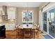 Elegant dining area with hardwood floors, a large table, and seamless access to the outdoor patio at 4193 W 99Th Ct, Westminster, CO 80031