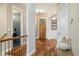 Inviting hallway features hardwood floors, stylish lighting, and views of the powder room and study at 4193 W 99Th Ct, Westminster, CO 80031