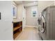Functional laundry room with shelving, tile flooring, and modern washer and dryer at 4193 W 99Th Ct, Westminster, CO 80031