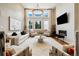 Bright living room featuring high ceilings, large windows, modern fireplace, and contemporary furnishings at 4193 W 99Th Ct, Westminster, CO 80031