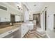 Luxurious bathroom featuring a soaking tub, glass shower, dual vanities, and stylish herringbone flooring at 4193 W 99Th Ct, Westminster, CO 80031