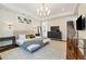 A well-lit main bedroom with a large rug, sleek furniture, access to the main bathroom and stairway at 4193 W 99Th Ct, Westminster, CO 80031
