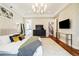 Bright main bedroom with ensuite bath and staircase access, featuring hardwood floors and stylish decor at 4193 W 99Th Ct, Westminster, CO 80031