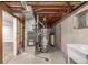 Utility area with water heater, furnace, and utility sink in an unfinished basement at 5316 S Jellison St, Littleton, CO 80123