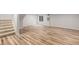 Spacious basement area featuring wood flooring, natural light, recessed lighting, and stairway at 5316 S Jellison St, Littleton, CO 80123