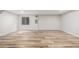 Spacious basement with wood flooring and natural light, offering versatility for recreation or storage at 5316 S Jellison St, Littleton, CO 80123