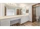 Bathroom features an extra-long vanity and a view to the bath and bedrooms at 5316 S Jellison St, Littleton, CO 80123