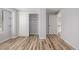 Bright bedroom featuring wood-look flooring and closet with sliding doors at 5316 S Jellison St, Littleton, CO 80123