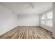 Well-lit bedroom featuring wood-look flooring, neutral walls, and large windows at 5316 S Jellison St, Littleton, CO 80123