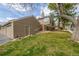 Side exterior view of home with green lawn and mature tree showing garage and entry to back patio at 5316 S Jellison St, Littleton, CO 80123