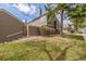 Side yard and portion of the rear of a townhome with mature landscaping on a sunny day at 5316 S Jellison St, Littleton, CO 80123