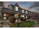 Evening view of a townhome with a covered porch and manicured landscaping with rock features at 5316 S Jellison St, Littleton, CO 80123