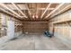 Spacious two car garage, bare walls, concrete floors with storage racks and a side door to the backyard at 5316 S Jellison St, Littleton, CO 80123