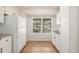 Functional kitchen featuring a white refrigerator, ample cabinetry, and hardwood floors at 5316 S Jellison St, Littleton, CO 80123