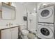 Small bathroom with stackable washer and dryer, shower, and vanity at 1260 Adams St, Denver, CO 80206