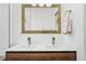 Modern bathroom with double vanity, gold fixtures, and white subway tile at 1260 Adams St, Denver, CO 80206