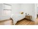 Bedroom with hardwood floors, a full bed, and a wooden nightstand at 1260 Adams St, Denver, CO 80206