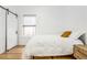 Bright bedroom with hardwood floors, a queen bed, and a sliding barn door at 1260 Adams St, Denver, CO 80206