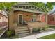 Brick home with a charming front porch at 1260 Adams St, Denver, CO 80206