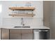 Modern kitchen with farmhouse sink and wooden shelves at 1260 Adams St, Denver, CO 80206