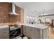 Modern kitchen with stainless steel appliances and exposed brick at 1260 Adams St, Denver, CO 80206