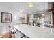 Modern kitchen with breakfast bar and exposed brick wall at 1260 Adams St, Denver, CO 80206