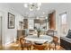 Modern kitchen with exposed brick, stainless steel appliances and round dining table at 1260 Adams St, Denver, CO 80206