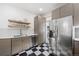 Modern kitchen with stainless steel appliances and black and white floor at 1260 Adams St, Denver, CO 80206