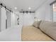 Basement bedroom with barn doors and ensuite bathroom at 1260 Adams St, Denver, CO 80206