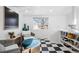 Cozy sitting area with blue ottoman and black and white floor at 1260 Adams St, Denver, CO 80206