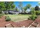 Grassy backyard, garden beds, mature trees, and ample room for recreation at 4545 S Lipan Ct, Englewood, CO 80110