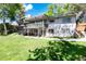 Two-story home with a deck and covered patio overlooking a spacious backyard at 4545 S Lipan Ct, Englewood, CO 80110