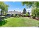 Fenced backyard offering a large grassy area, garden beds, and neighborhood views at 4545 S Lipan Ct, Englewood, CO 80110