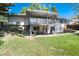 Backyard with a covered patio, deck, and a large grassy area for outdoor enjoyment at 4545 S Lipan Ct, Englewood, CO 80110