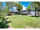Spacious backyard featuring mature trees, a well-manicured lawn, and a cozy patio at 4545 S Lipan Ct, Englewood, CO 80110
