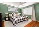 Charming bedroom with hardwood floors, a ceiling fan, and large windows at 4545 S Lipan Ct, Englewood, CO 80110