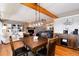 Inviting dining room with wood floors, fireplace, built-in shelving, and exposed beams at 4545 S Lipan Ct, Englewood, CO 80110